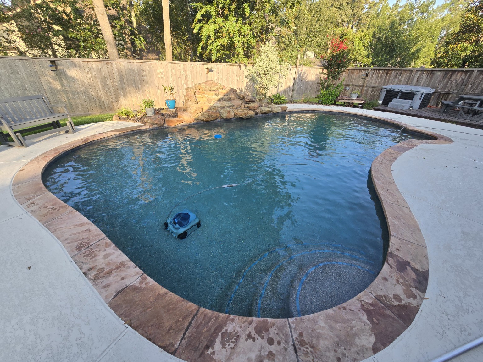 Clean residential swimming pool serviced by Aqua Heart Pools in the Conroe area