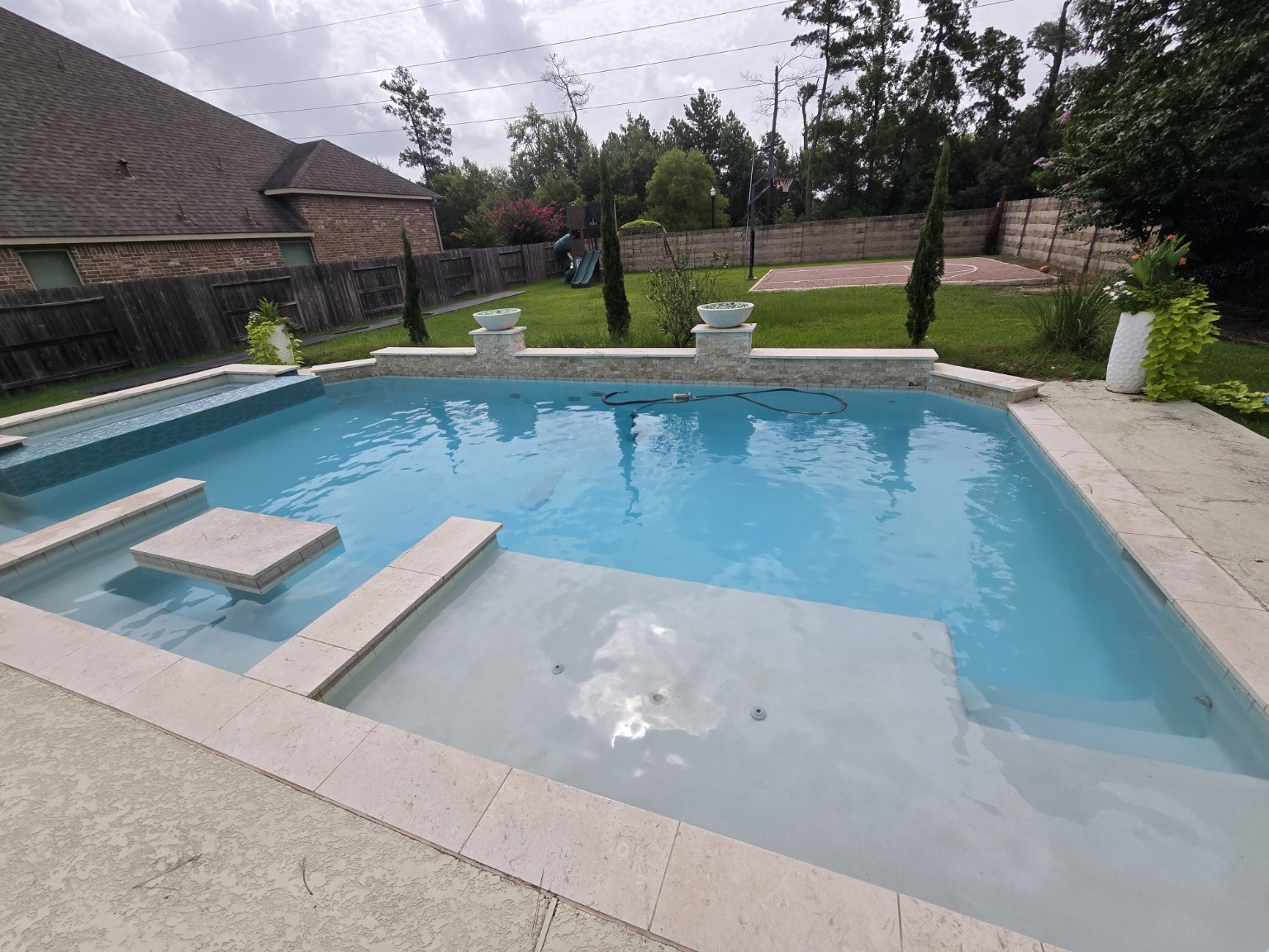 Clean residential swimming pool serviced by Aqua Heart Pools in Spring Texas